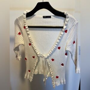 Valentine’s day sweater with hearts, ruffle trim and front tie